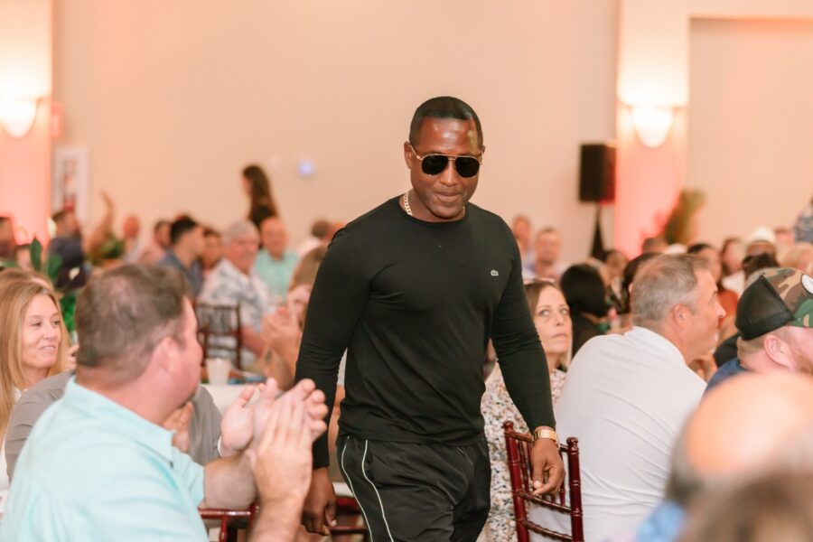 a man walking through a room full of people