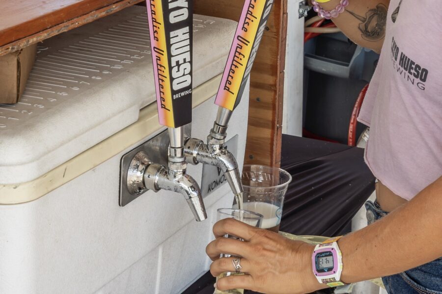 a person filling a glass of water from a faucet
