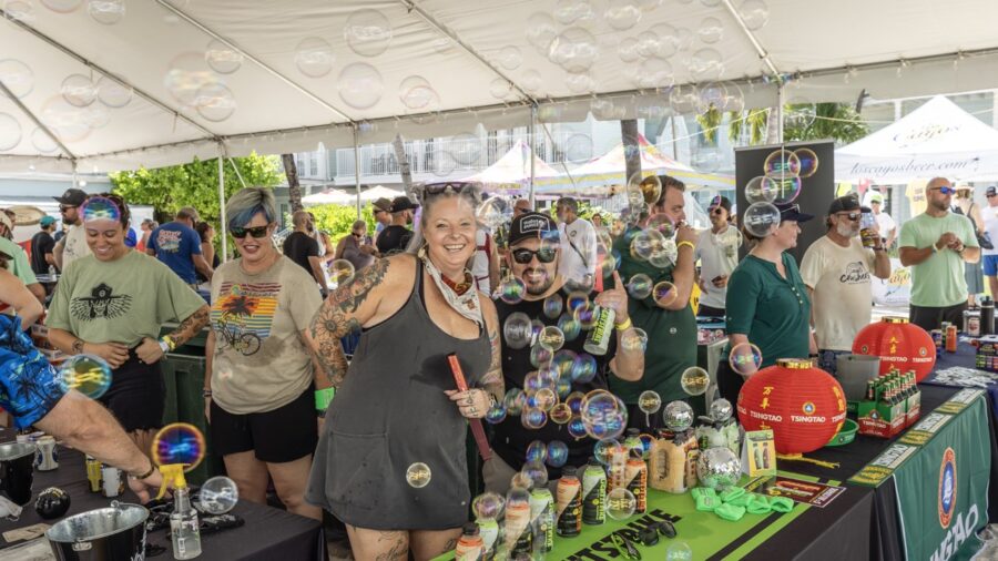 a group of people standing around a table covered in bubbles