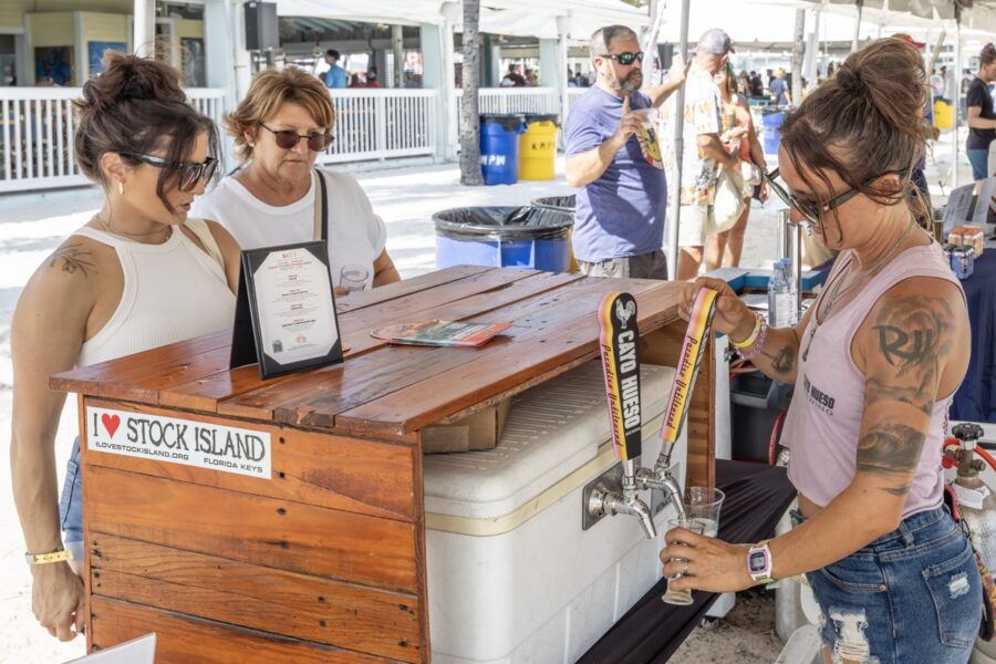 a group of people standing around a wooden table