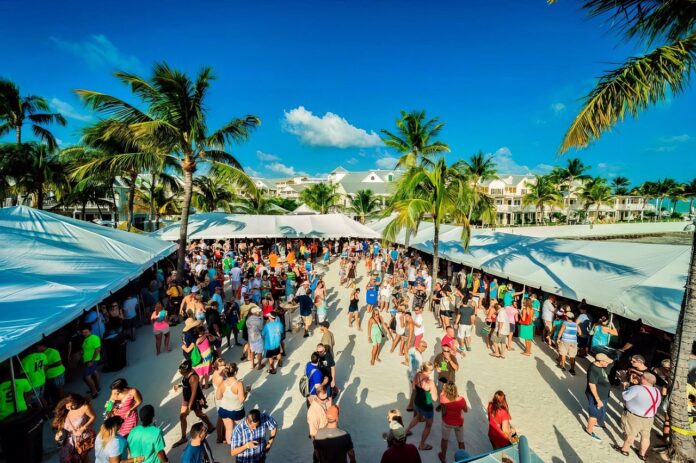 Brewfest01 Large a crowd of people walking down a street next to palm trees