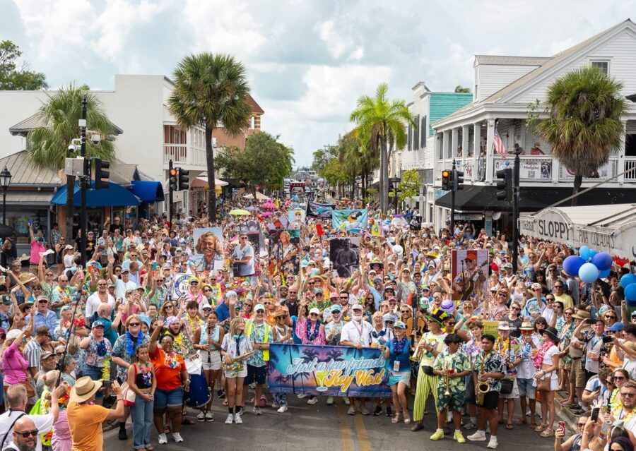 a crowd of people standing on the side of a road