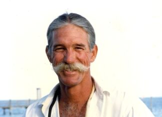 a man with a mustache and a white shirt