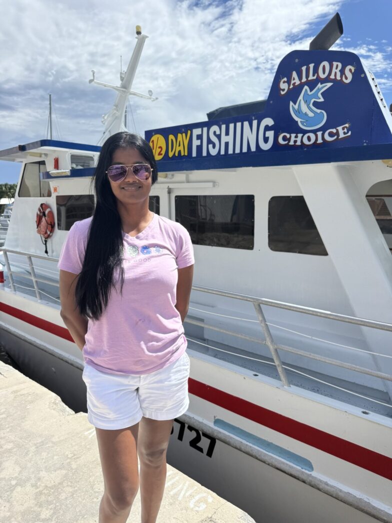 a woman standing on a dock next to a boat