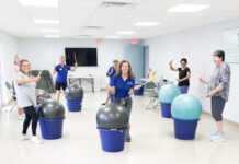 a group of people in a room with exercise balls
