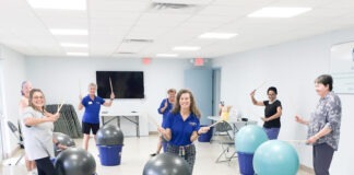 a group of people in a room with exercise balls