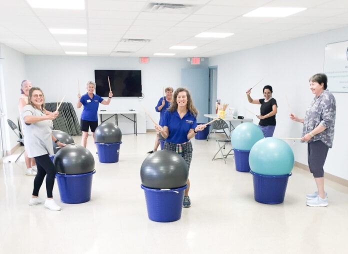 a group of people in a room with exercise balls