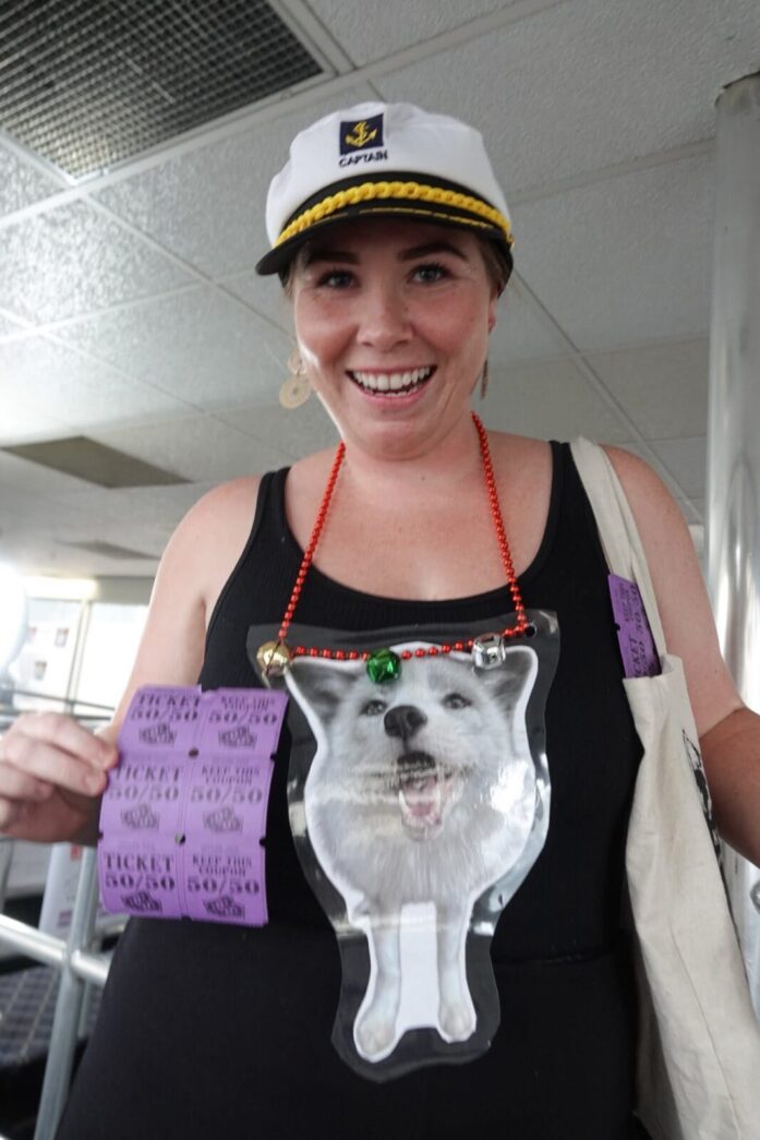 a woman wearing a hat and a t - shirt with a picture of a dog