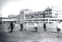 a group of people standing in front of a large building