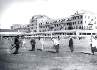 a group of people standing in front of a large building