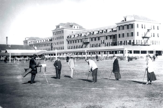 a group of people standing in front of a large building