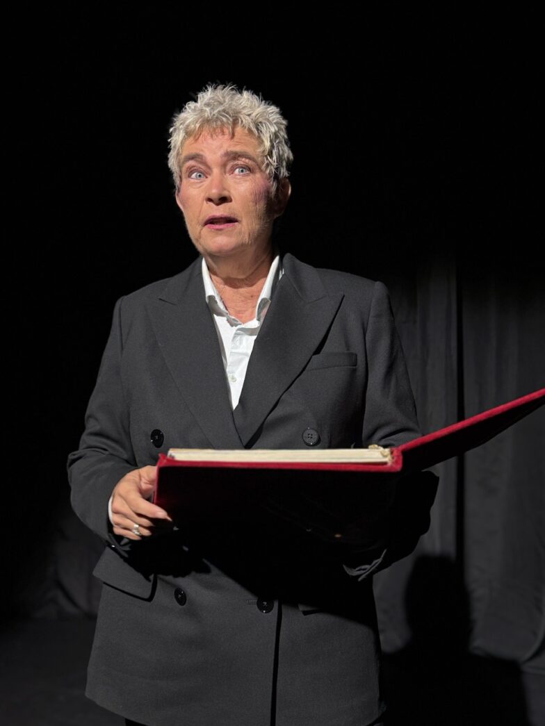 a man in a suit holding a book