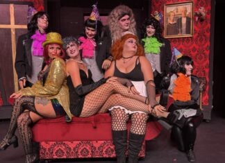 a group of women dressed in costumes sitting on a couch