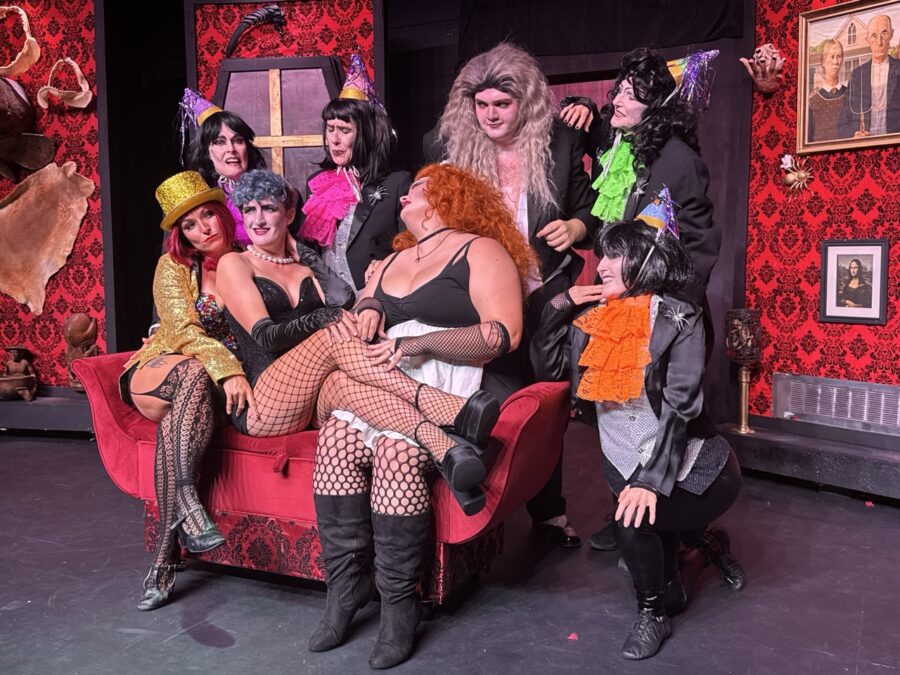 a group of people sitting on top of a red couch