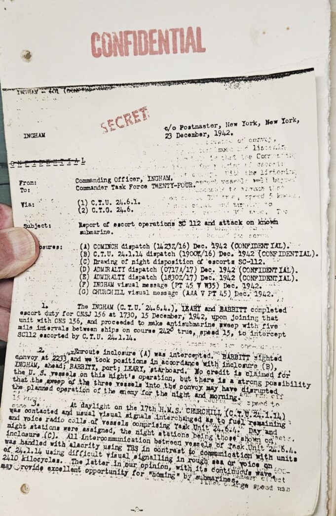 a hand holding a piece of paper with writing on it
