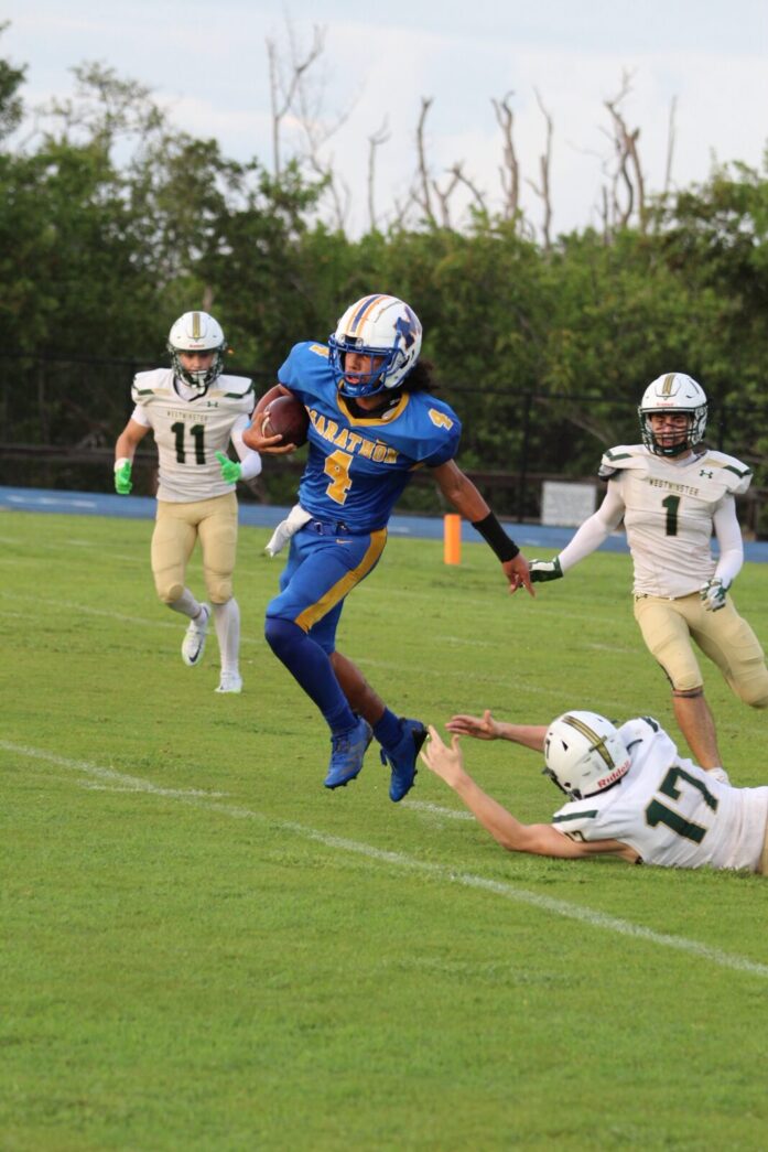 a football player running with the ball during a game