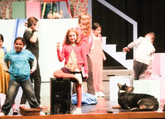 a group of people standing on top of a stage