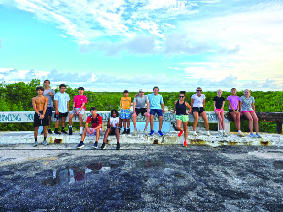 a group of people standing on top of a rock
