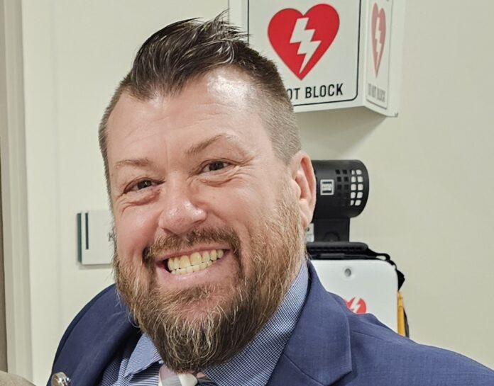 a man in a suit and tie smiling