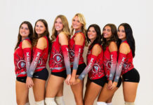 a group of beautiful women standing next to each other