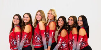 a group of beautiful women standing next to each other