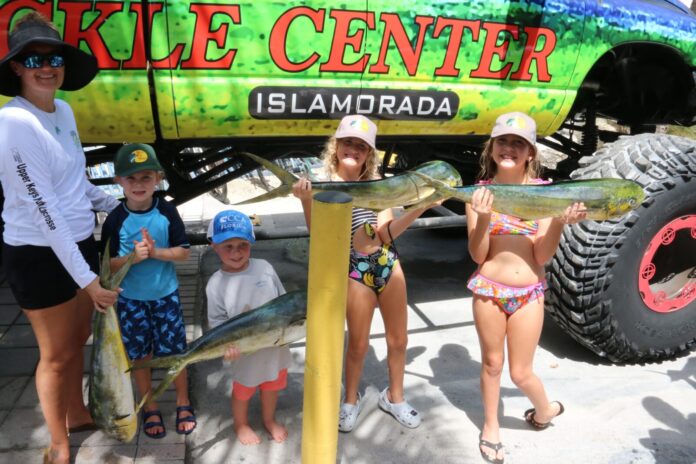 Keys kids fish 1 a group of people standing in front of a truck