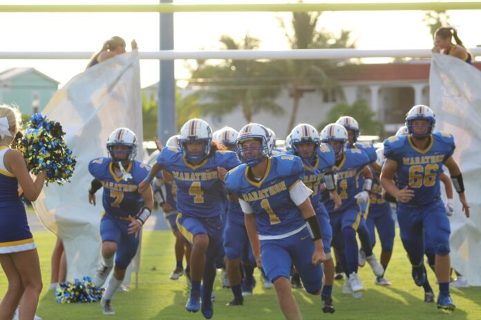MHS 0 Large a football team running onto the field