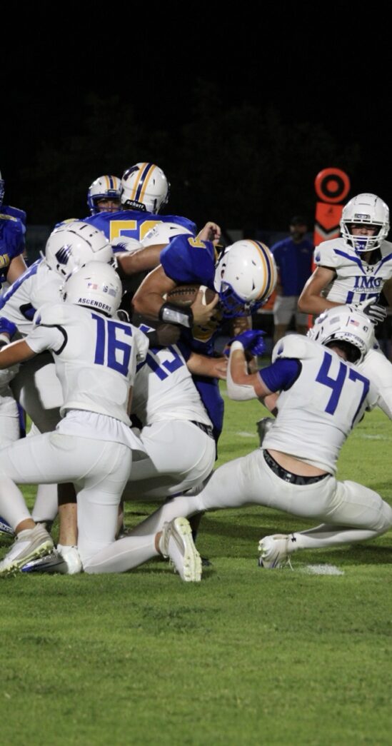 a group of football players playing a game of football