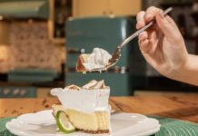 a person is eating a piece of pie with a fork