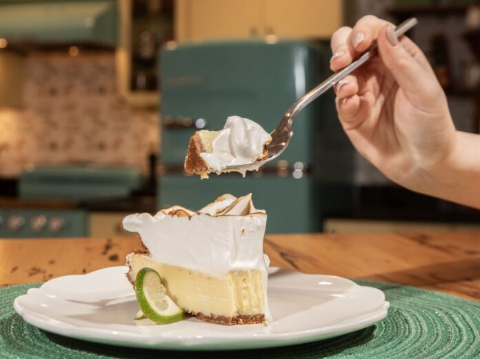 NEW_4859 a person is eating a piece of pie with a fork