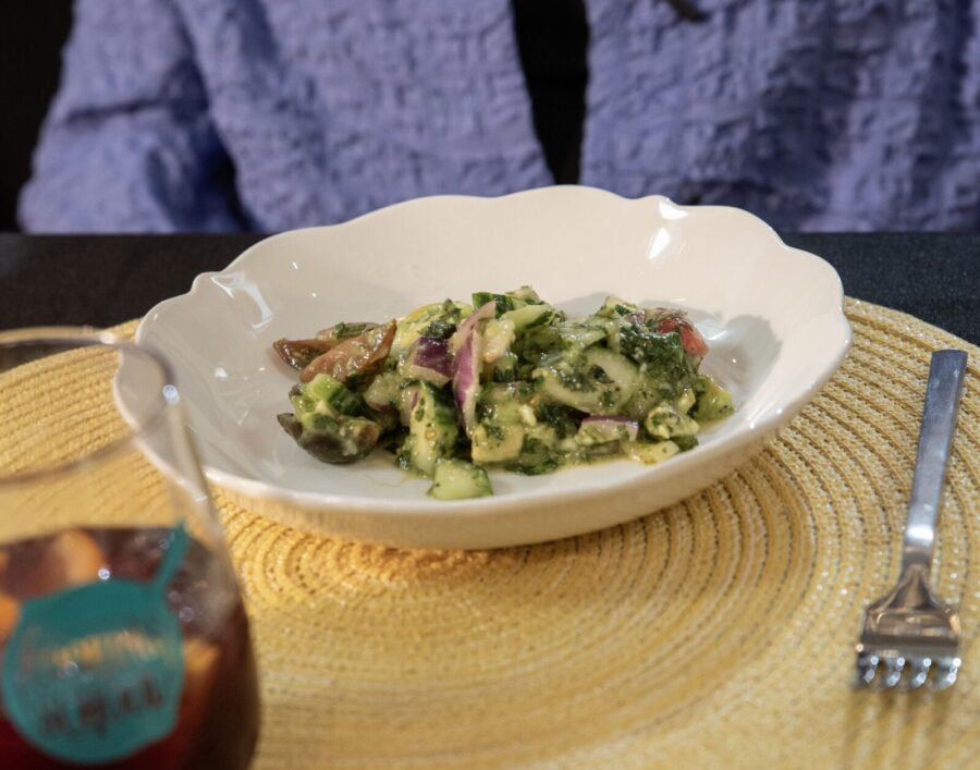 a plate of food on a table with a glass of wine