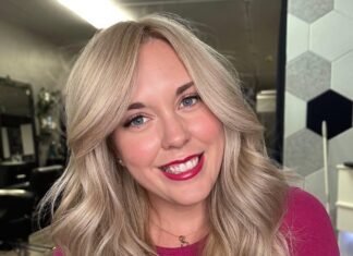 a woman with blonde hair and a pink shirt