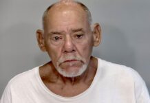 a man in a white shirt looking at the camera