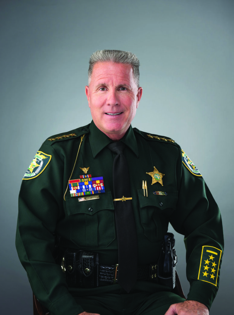 a man in a uniform sitting in a chair