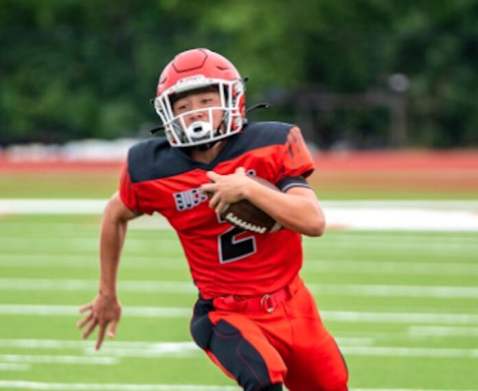 a football player is running with the ball
