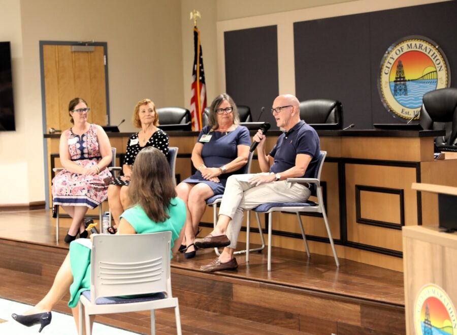 a group of people sitting in chairs in a room