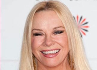 a woman with blonde hair smiling at the camera