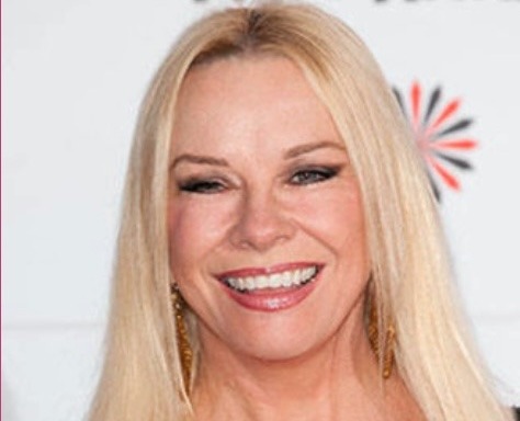 Screenshot a woman with blonde hair smiling at the camera