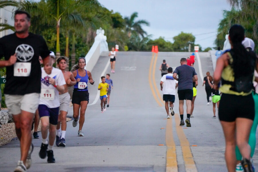 a group of people running down a street