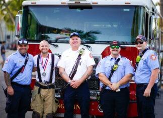 a group of men standing in front of a fire truck