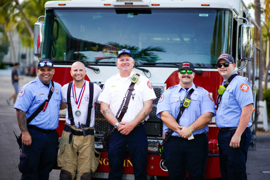 a group of men standing in front of a fire truck