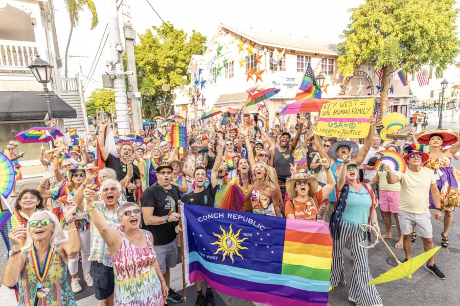 a group of people holding a rainbow flag