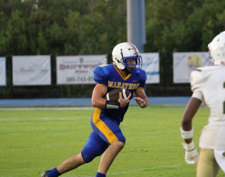 a football player running with the ball during a game