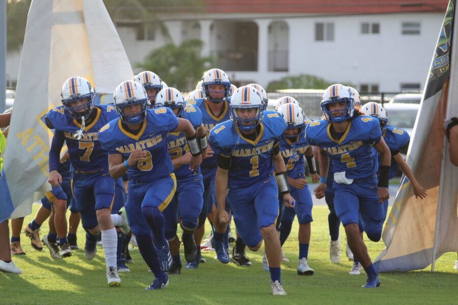 a football team running onto the field
