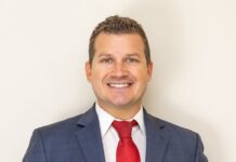 a man in a suit and red tie