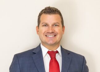 a man in a suit and red tie