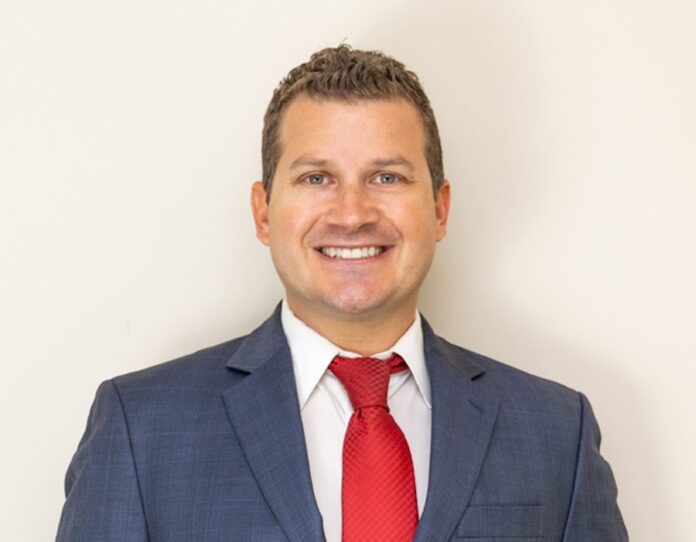 a man in a suit and red tie
