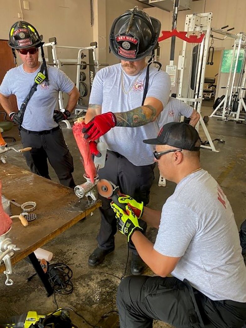 a group of men working on a skateboard in a garage