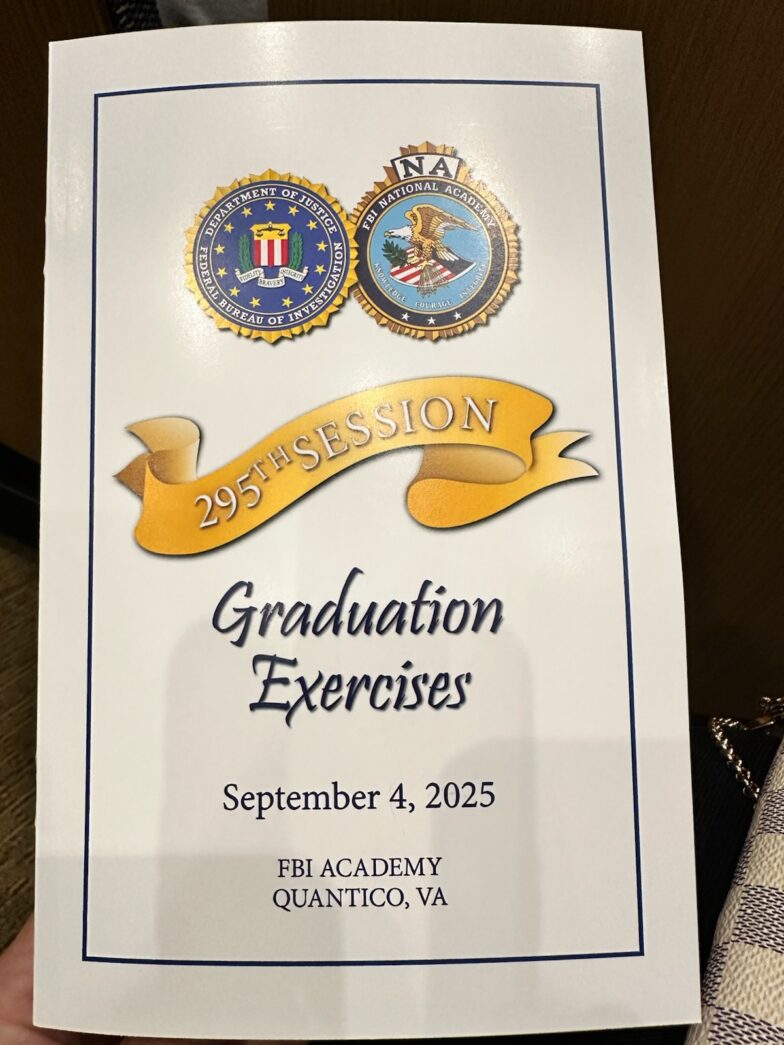 a person holding a sign that says graduation exercises