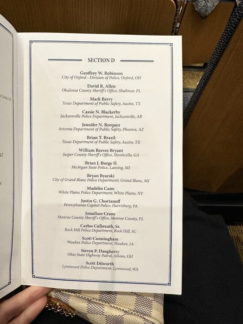 a person holding up a menu in their hand